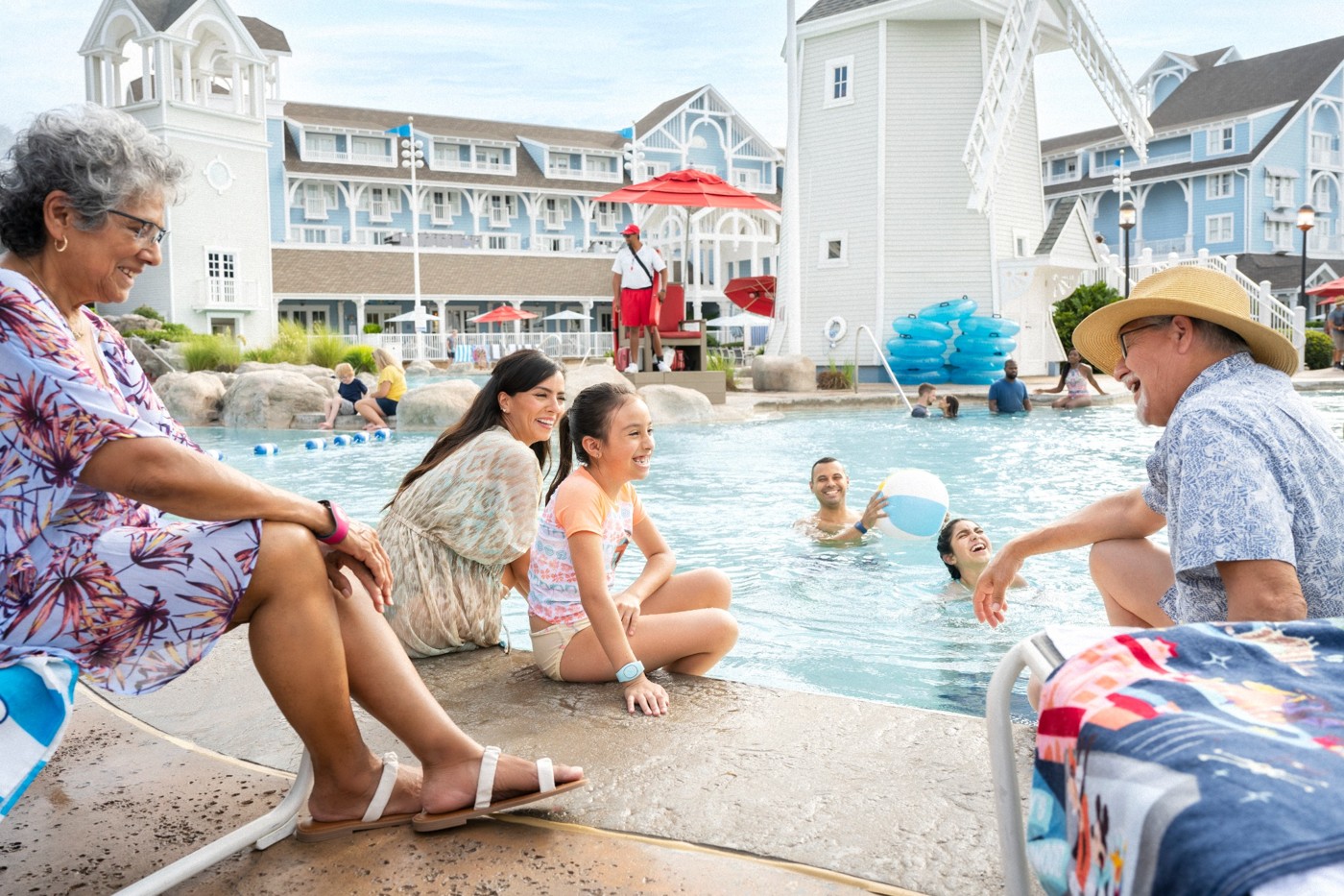 A family relaxing together at a Disney resort pool.