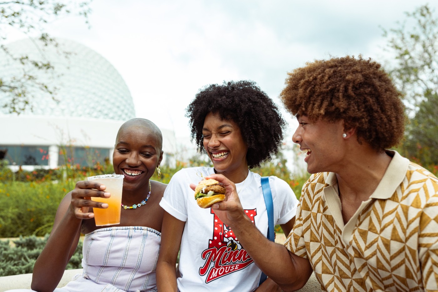 Friends enjoying food and drinks together at EPCOT.
